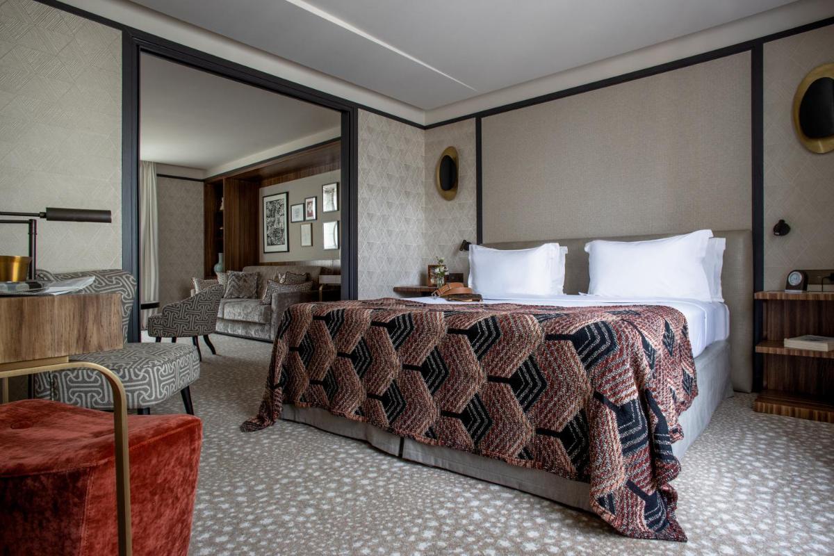 une chambre avec un grand lit avec un grand miroir dans l'établissement Esprit Saint Germain, à Paris