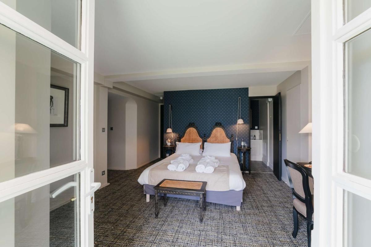 Un ou plusieurs lits dans un hébergement de l'établissement Hôtel La Robéyère - BW Signature Collection
