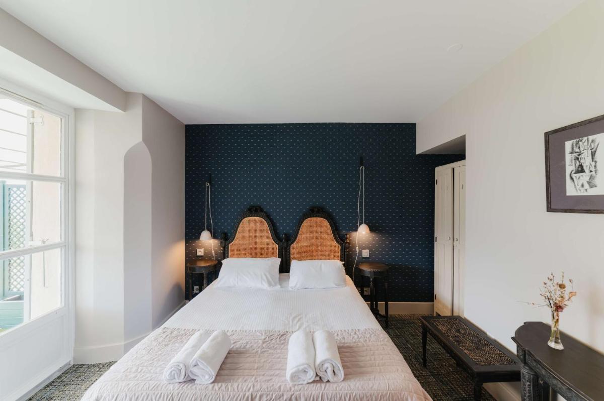 Un ou plusieurs lits dans un hébergement de l'établissement Hôtel La Robéyère - BW Signature Collection