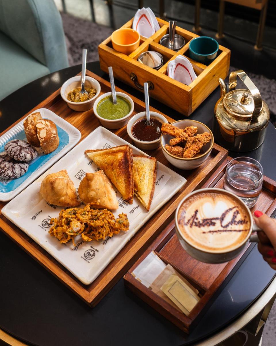 a table topped with plates of food on a table at Shangri-La Eros New Delhi in New Delhi a table topped with plates of food on a table at Shangri-La Eros New Delhi in New Delhi
