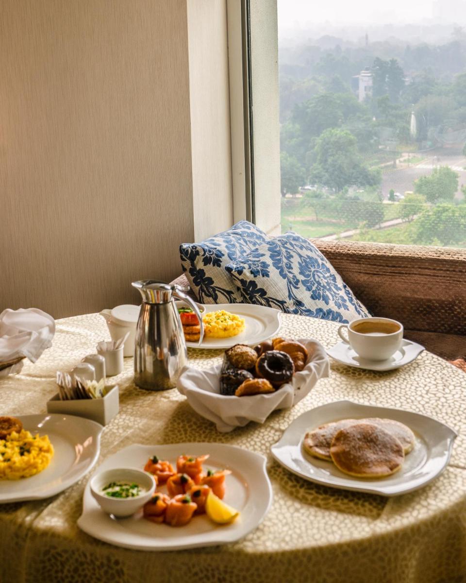 a table with plates of breakfast food on it at Shangri-La Eros New Delhi in New Delhi a table with plates of breakfast food on it at Shangri-La Eros New Delhi in New Delhi