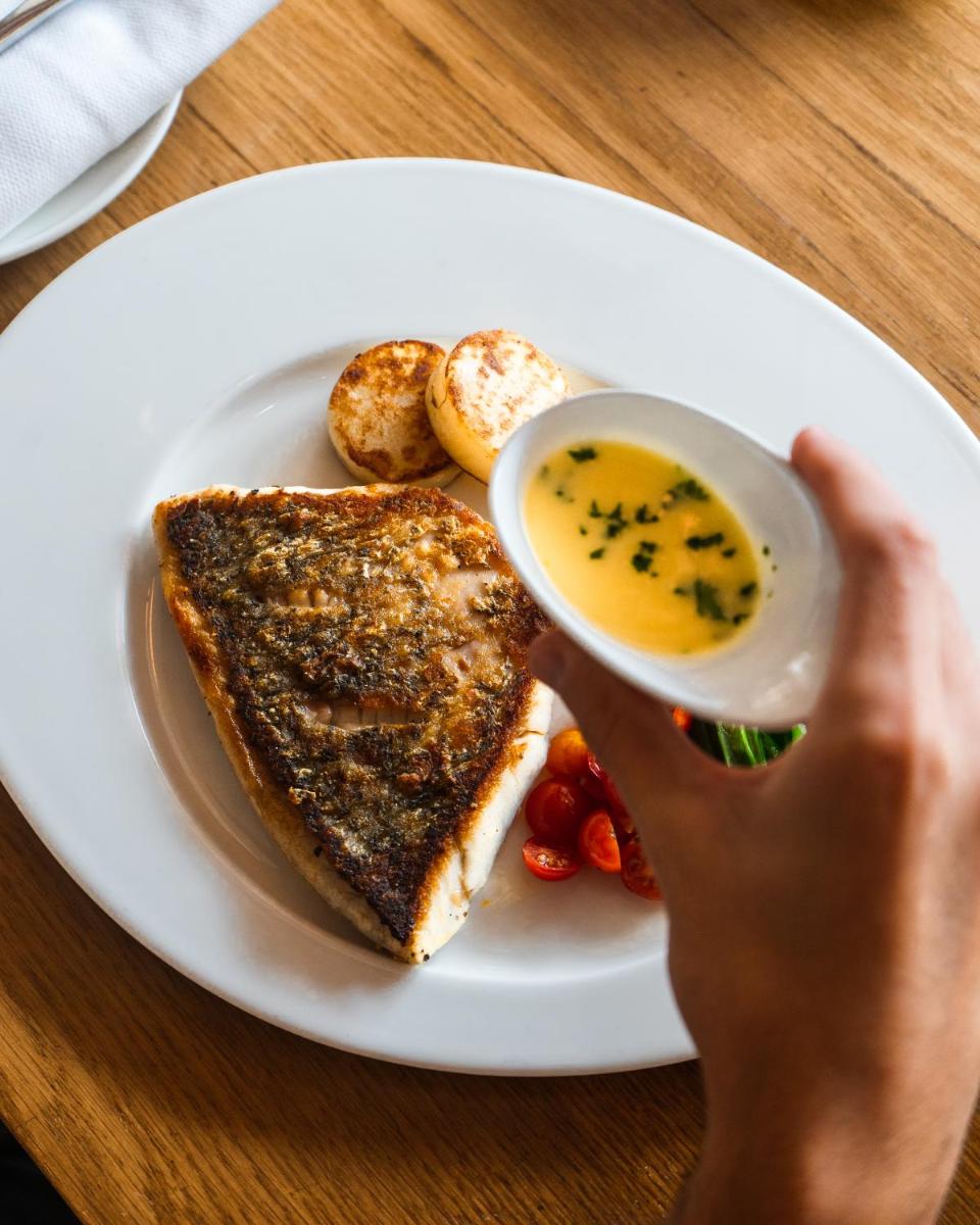 a person is holding a cup of soup next to a plate of toast at Shangri-La Eros New Delhi in New Delhi a person is holding a cup of soup next to a plate of toast at Shangri-La Eros New Delhi in New Delhi