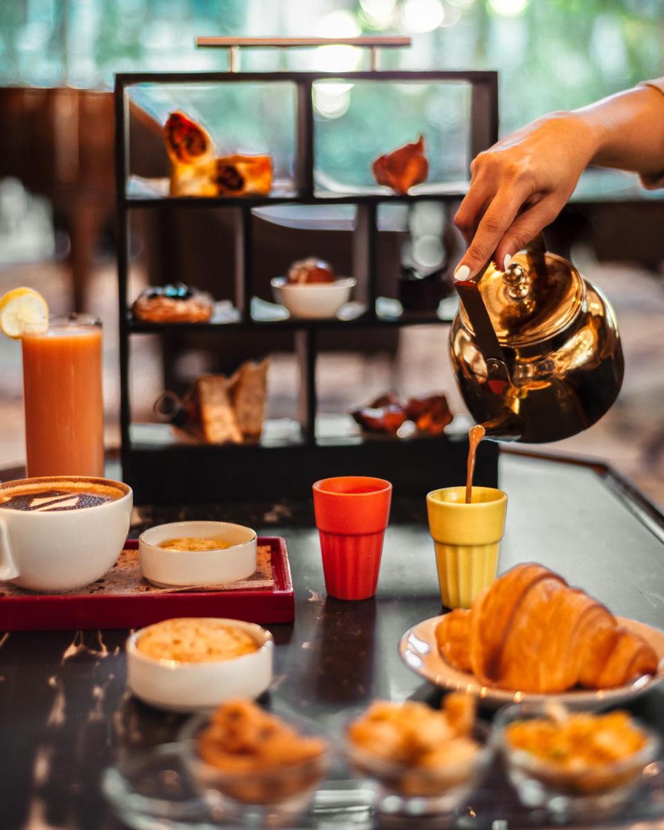 a person is pouring food into a teapot at Shangri-La Bengaluru in Bengaluru a person is pouring food into a teapot at Shangri-La Bengaluru in Bengaluru