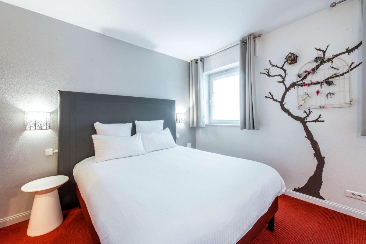 Un ou plusieurs lits dans un hébergement de l'établissement Best Western Plus Au cheval Blanc à Mulhouse