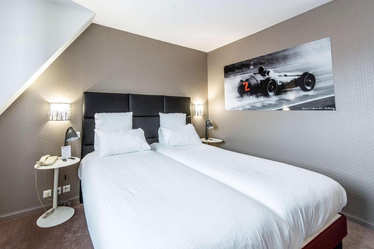 Un ou plusieurs lits dans un hébergement de l'établissement Best Western Plus Au cheval Blanc à Mulhouse