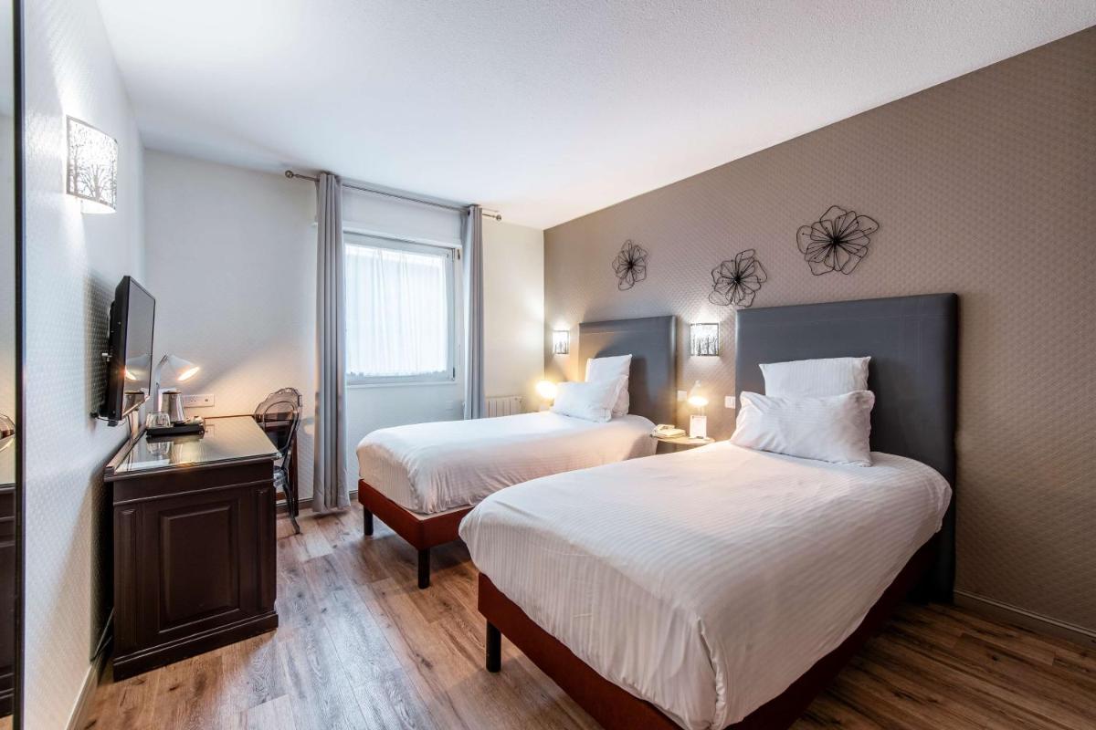 Un ou plusieurs lits dans un hébergement de l'établissement Best Western Plus Au cheval Blanc à Mulhouse