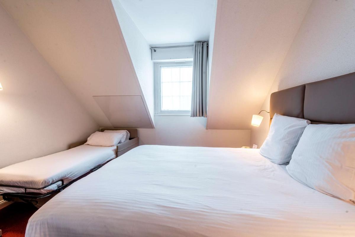 Un ou plusieurs lits dans un hébergement de l'établissement Best Western Plus Au cheval Blanc à Mulhouse