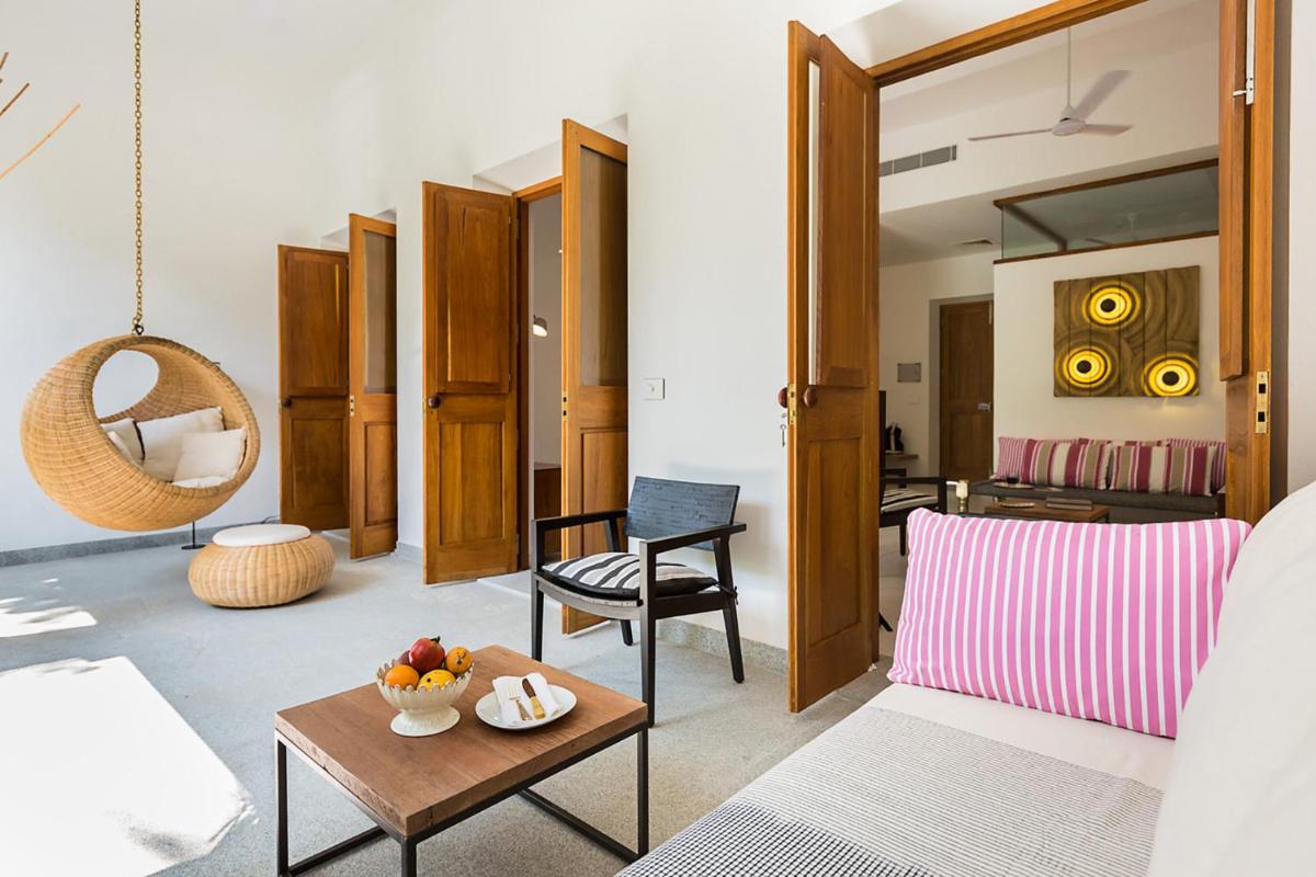 a living room with a couch and a table at La Villa in Puducherry