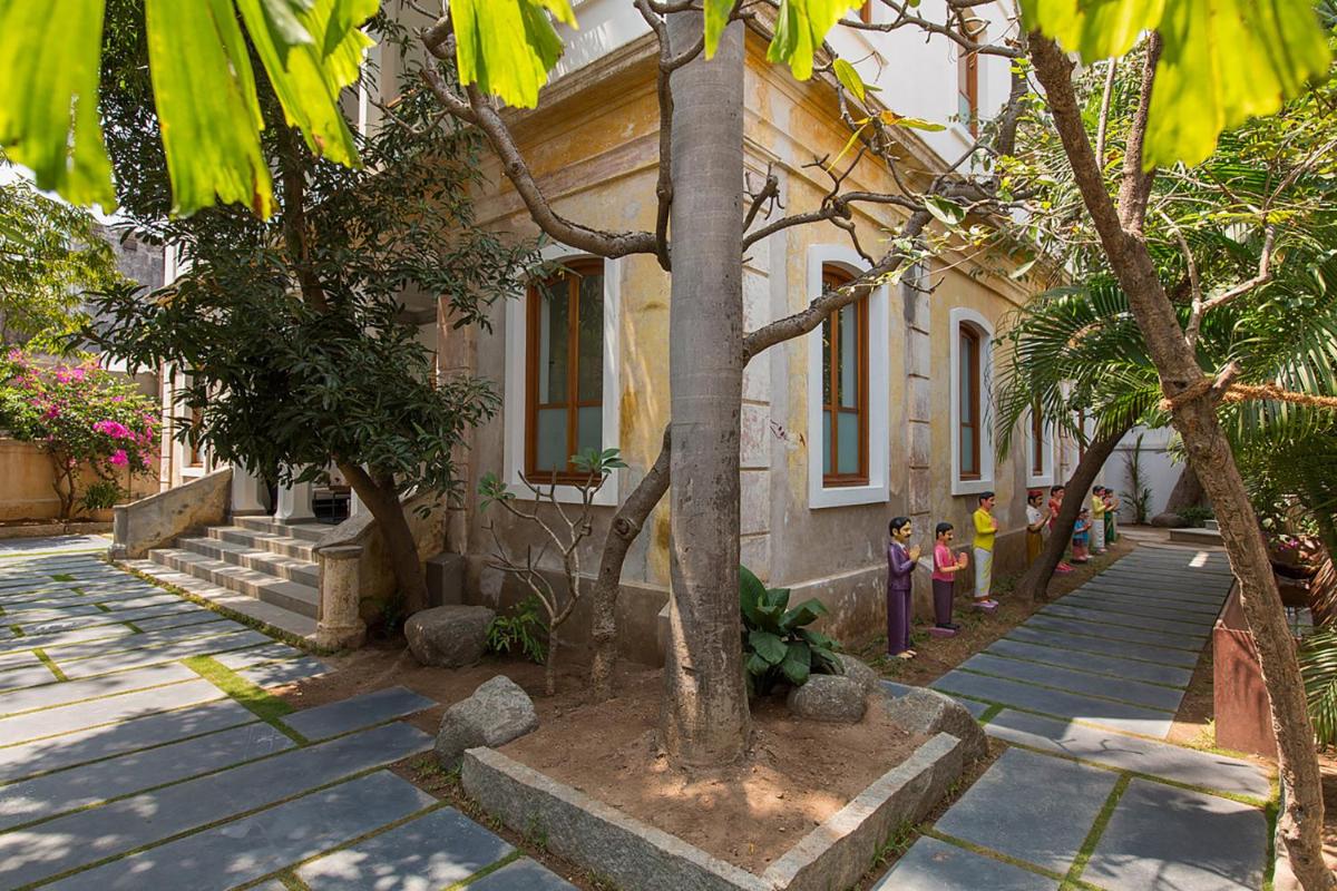 a house with trees in front of it at La Villa in Puducherry