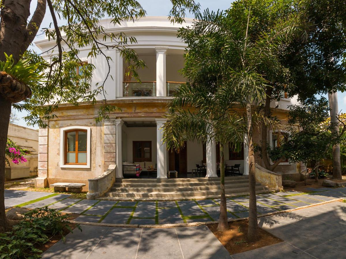 an old house with trees in front of it at La Villa in Puducherry