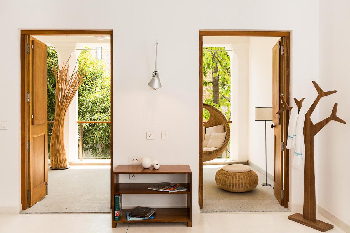 a living room with a mirror and a table at La Villa in Puducherry
