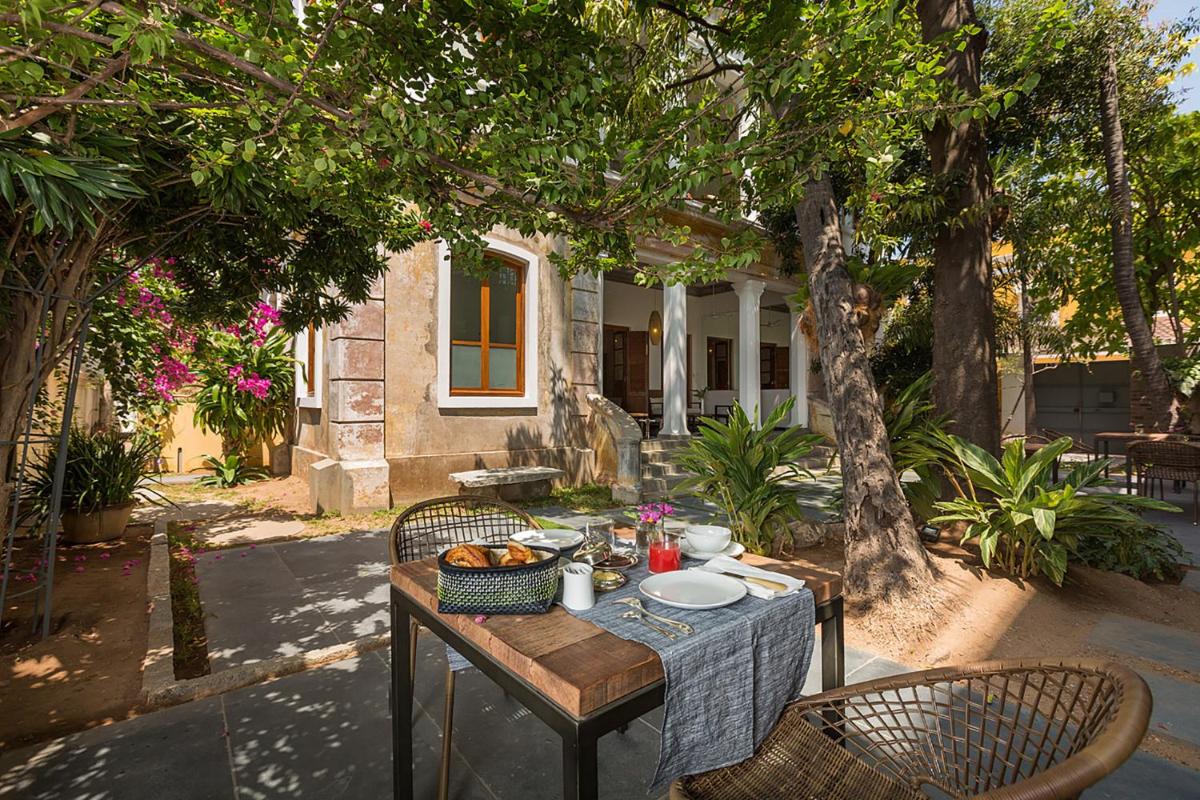 a table with a bowl of food on it at La Villa in Puducherry
