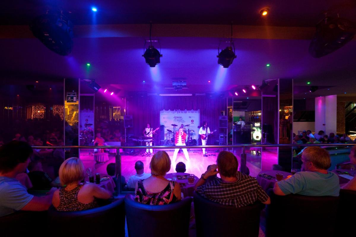 Un grupo de personas sentadas en una habitación viendo un concierto. en Paradise Park Fun Lifestyle Hotel, en Los Cristianos 75 fotos más