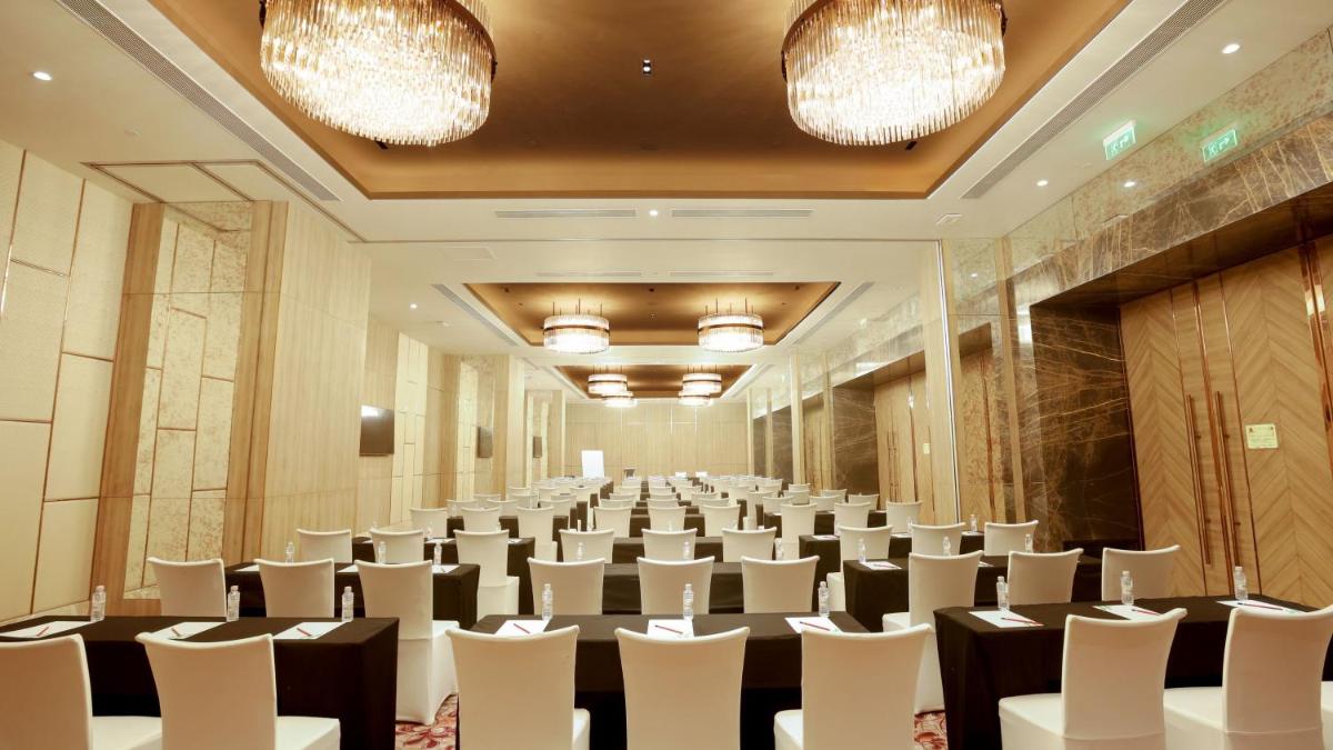 a conference room with rows of tables and chairs at Holiday Inn Gurugram Sector 90 by IHG in Gurgaon