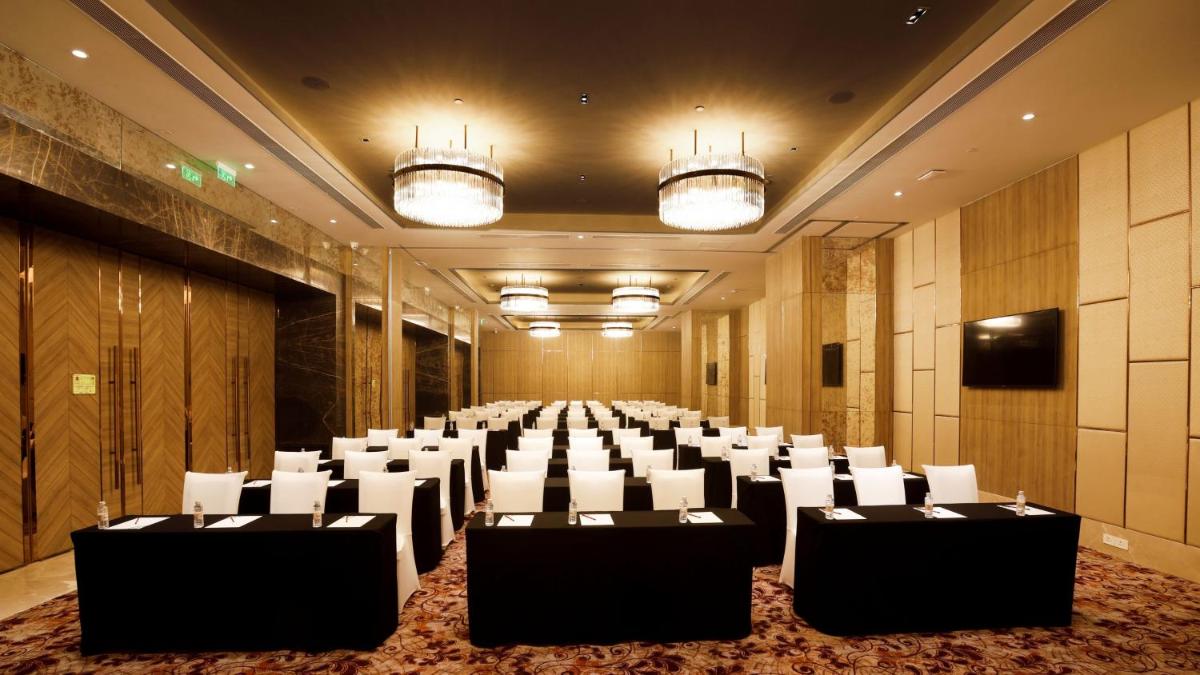 a conference room with tables and chairs in it at Holiday Inn Gurugram Sector 90 by IHG in Gurgaon