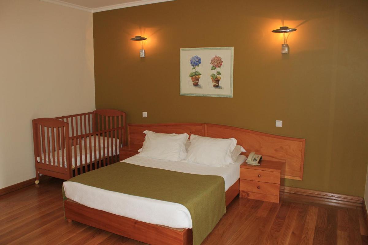 Uma cama ou camas num quarto em Eira do Serrado - Hotel & Spa