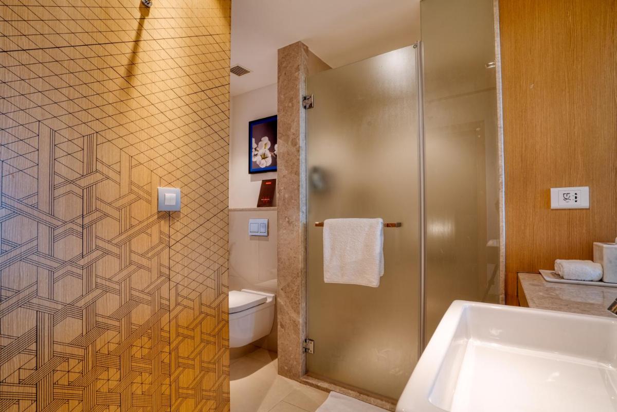 a bathroom with a shower and a toilet and a sink at Welcomhotel by ITC Hotels, RaceCourse, Coimbatore in Coimbatore