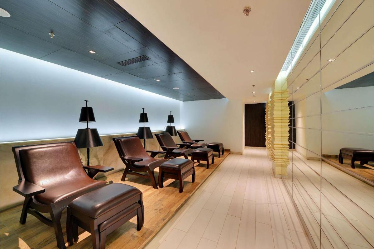 a waiting room with leather chairs and a waiting table at Wyndham Ahmedabad Shela in Ahmedabad