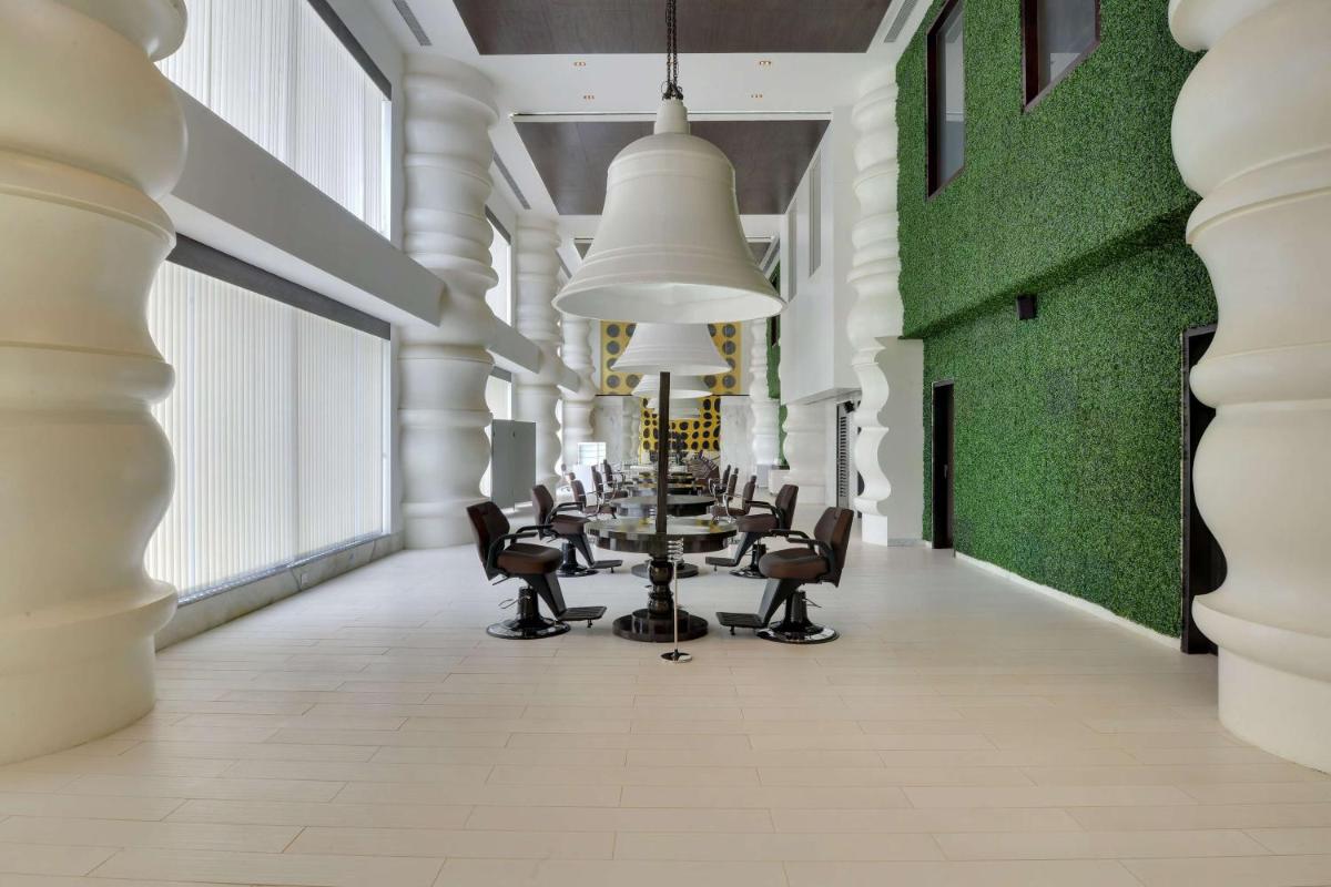 a long corridor with a long table and chairs at Wyndham Ahmedabad Shela in Ahmedabad