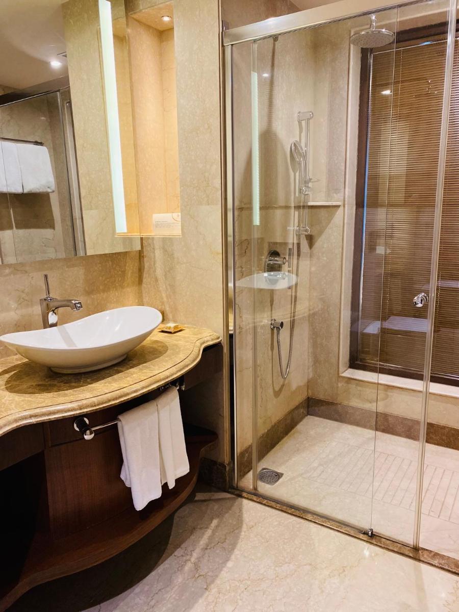 a bathroom with a sink and a shower at Seven Seas Hotel in New Delhi