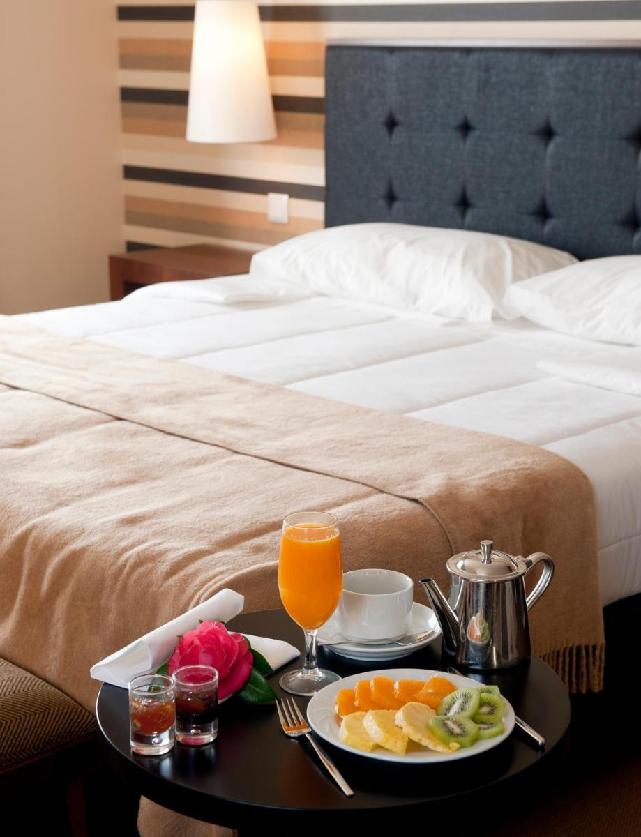 Uma cama ou camas num quarto em Grande Hotel De Luso
