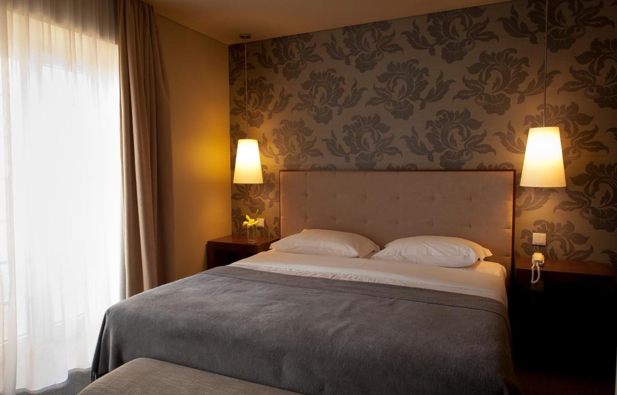 Uma cama ou camas num quarto em Grande Hotel De Luso