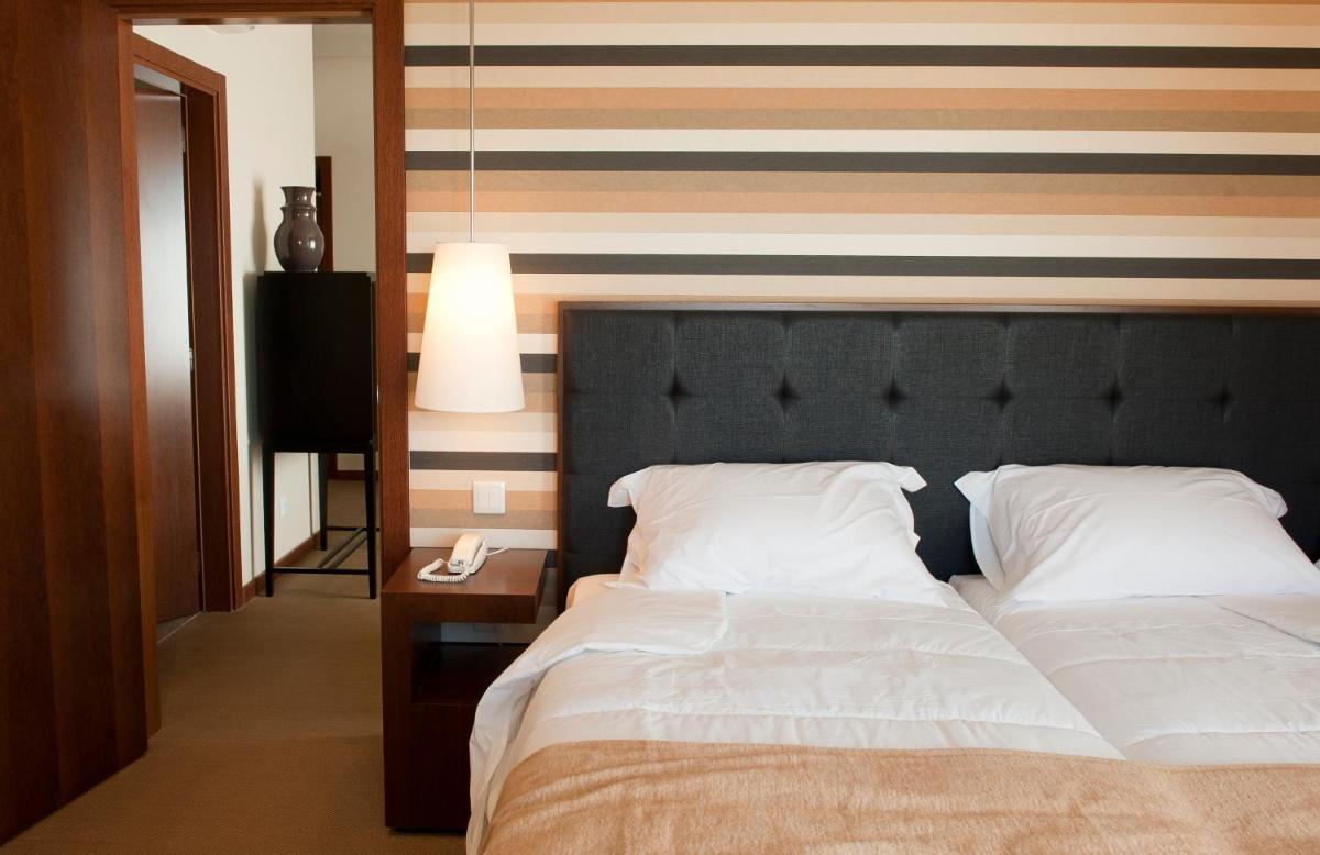 Uma cama ou camas num quarto em Grande Hotel De Luso
