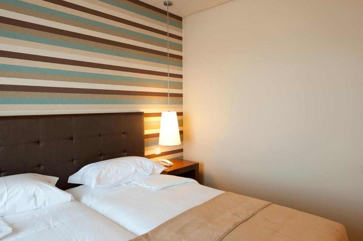 Uma cama ou camas num quarto em Grande Hotel De Luso