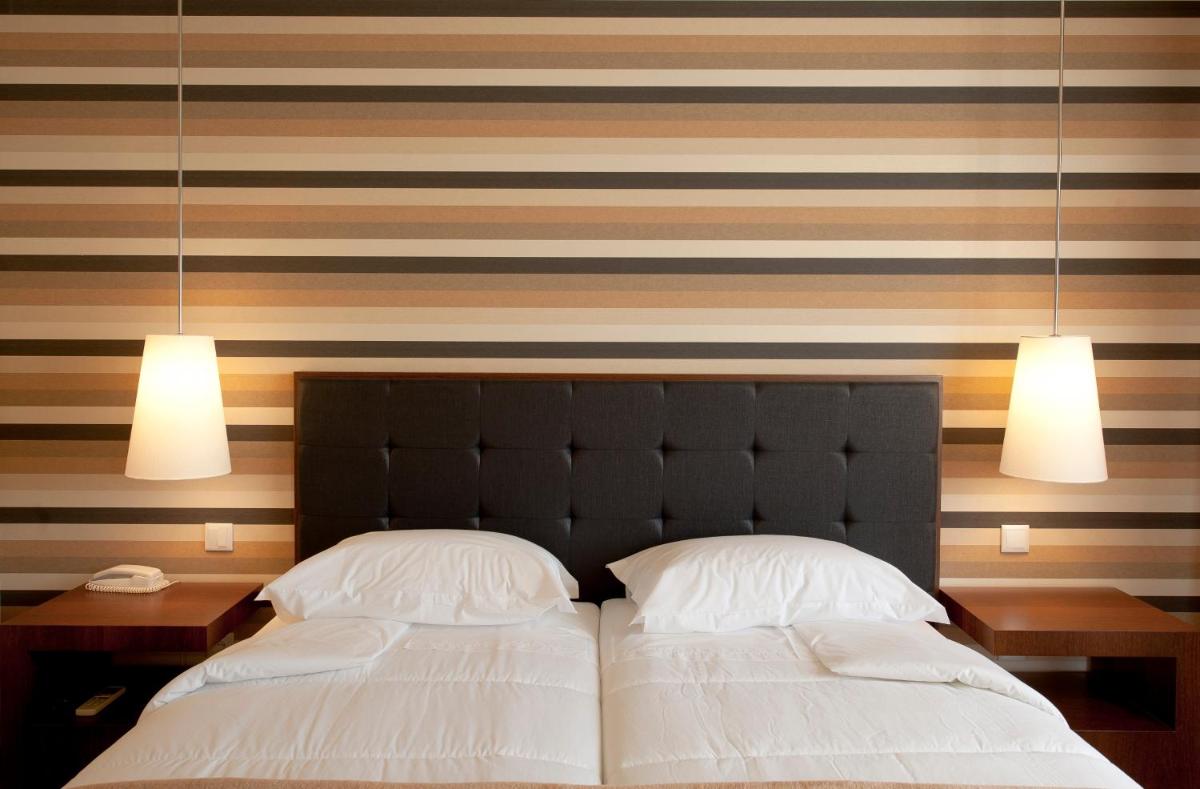 Uma cama ou camas num quarto em Grande Hotel De Luso