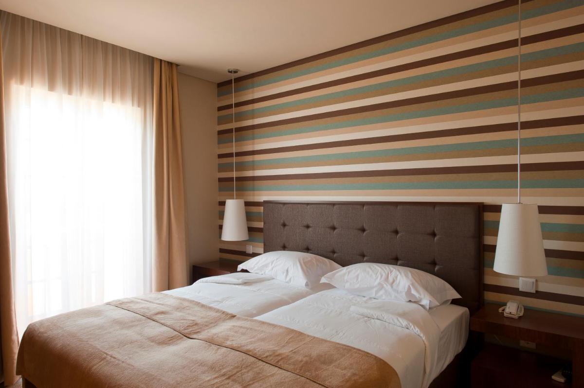 Uma cama ou camas num quarto em Grande Hotel De Luso