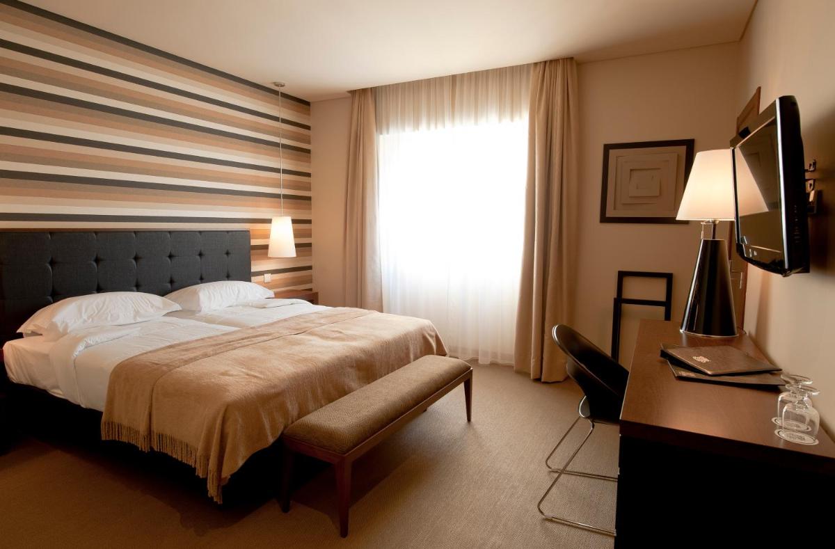 Uma cama ou camas num quarto em Grande Hotel De Luso