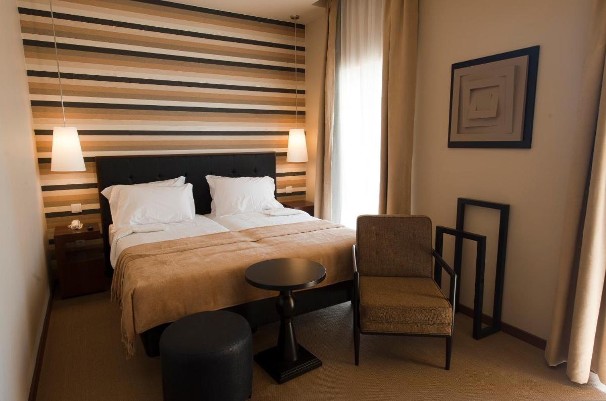 Uma cama ou camas num quarto em Grande Hotel De Luso