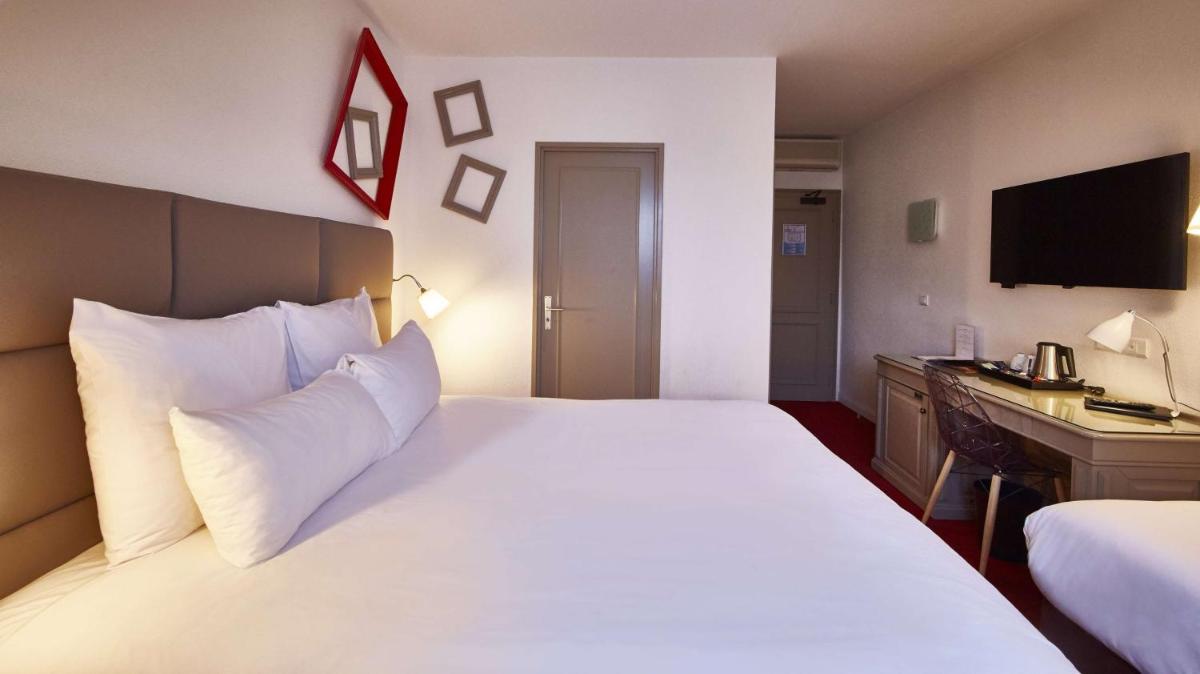 Un ou plusieurs lits dans un hébergement de l'établissement Best Western Plus Au cheval Blanc à Mulhouse