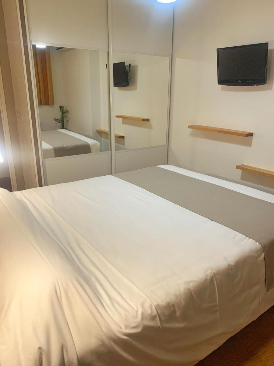 Un ou plusieurs lits dans un hébergement de l'établissement Hôtel Beau Soleil