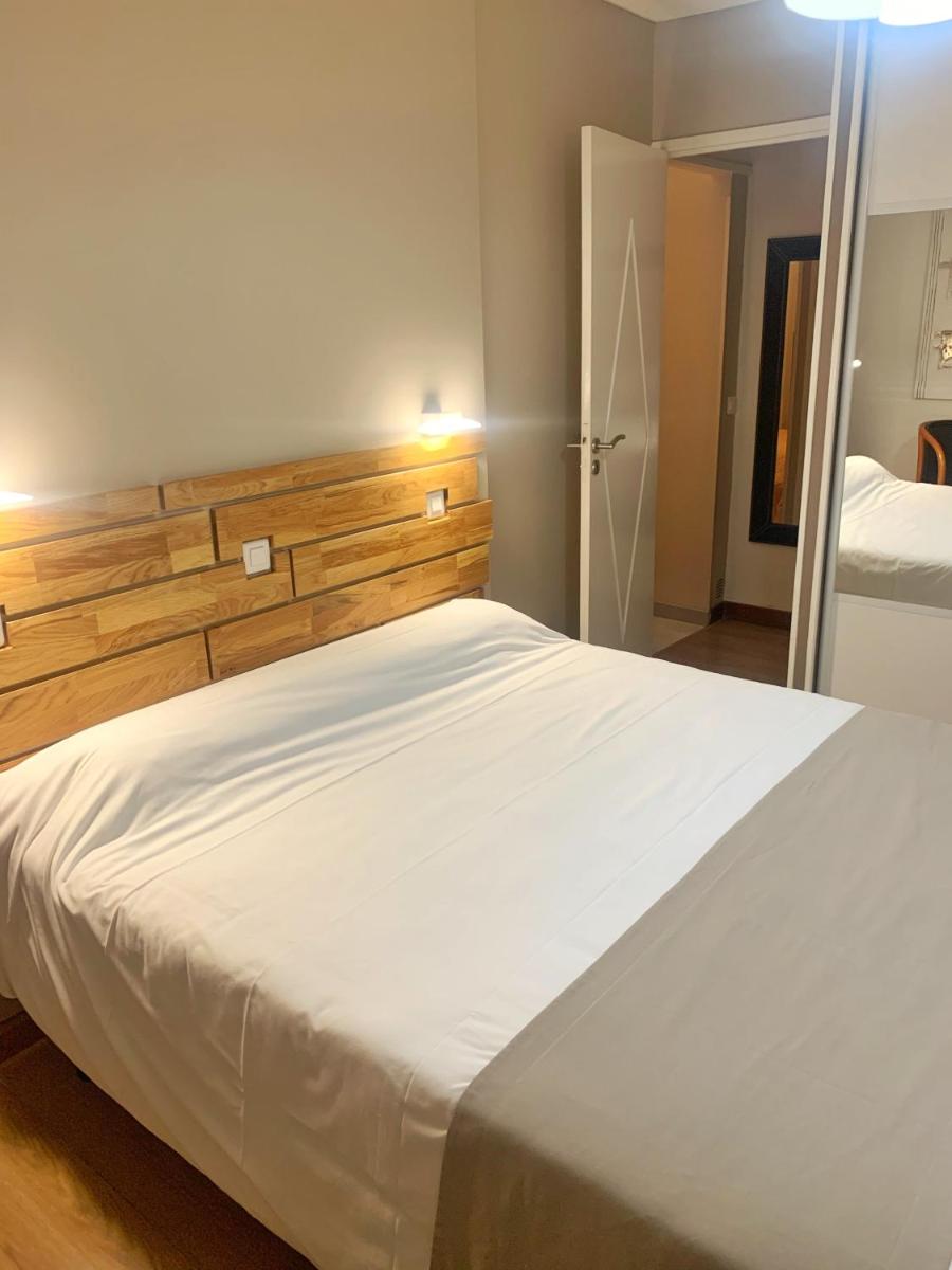 Un ou plusieurs lits dans un hébergement de l'établissement Hôtel Beau Soleil