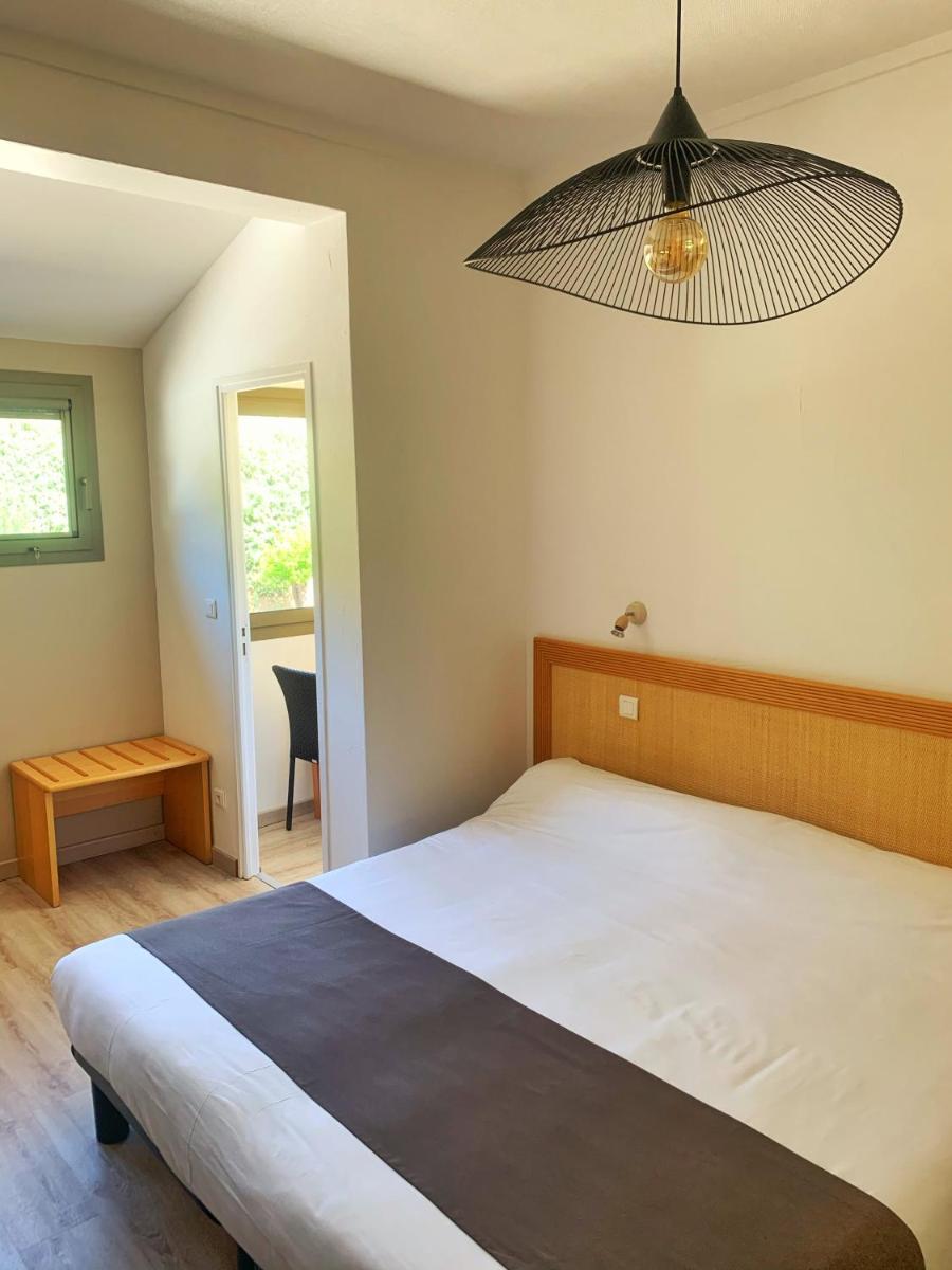 Un ou plusieurs lits dans un hébergement de l'établissement Hôtel Beau Soleil