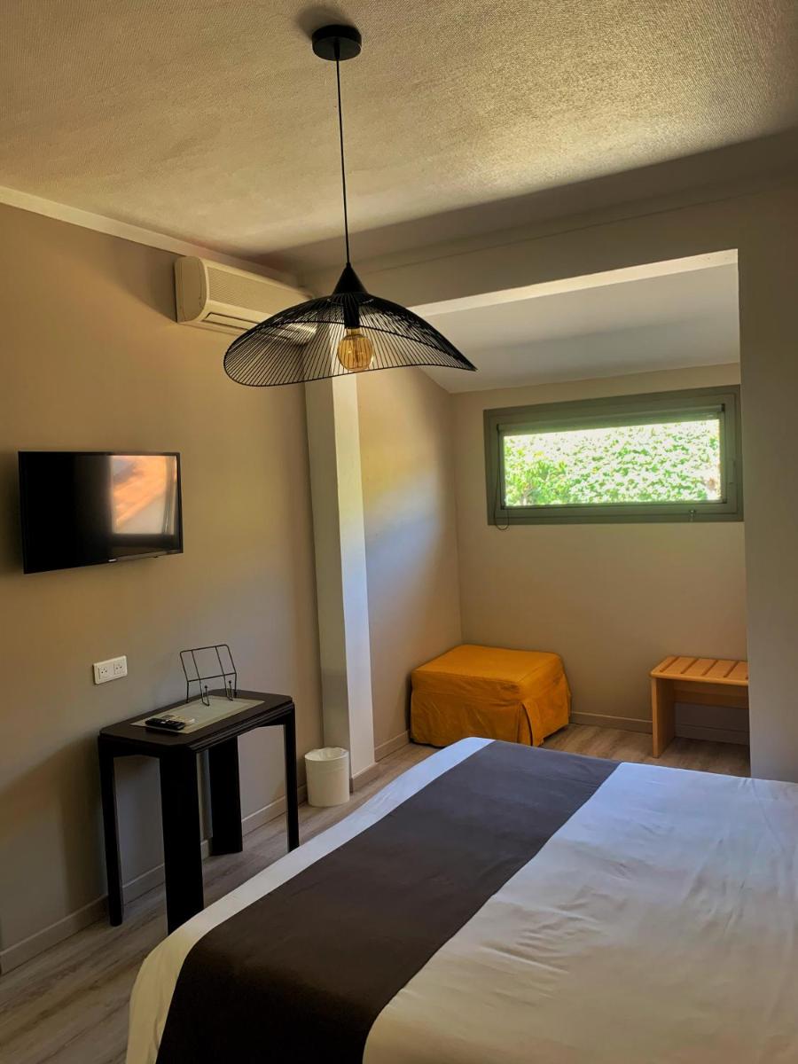 Un ou plusieurs lits dans un hébergement de l'établissement Hôtel Beau Soleil