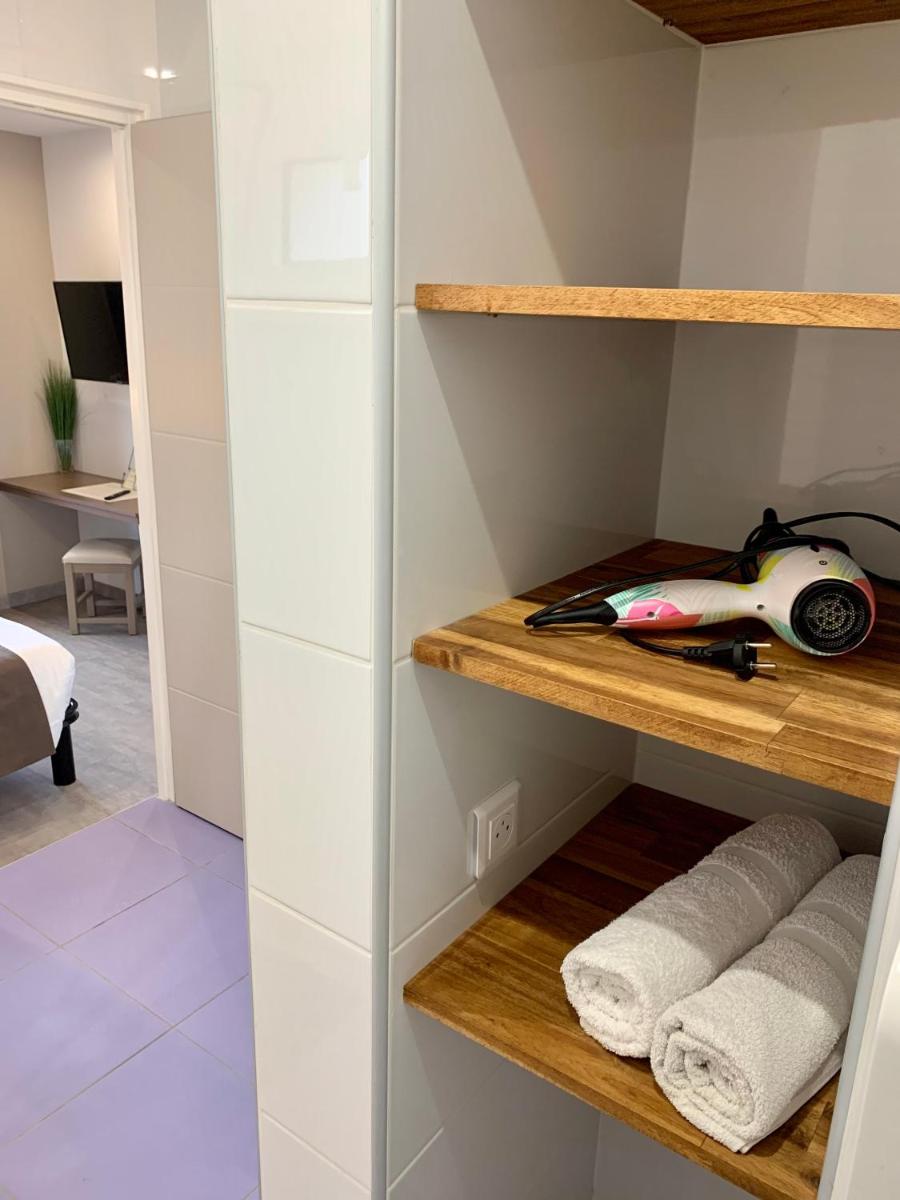 Un ou plusieurs lits dans un hébergement de l'établissement Hôtel Beau Soleil