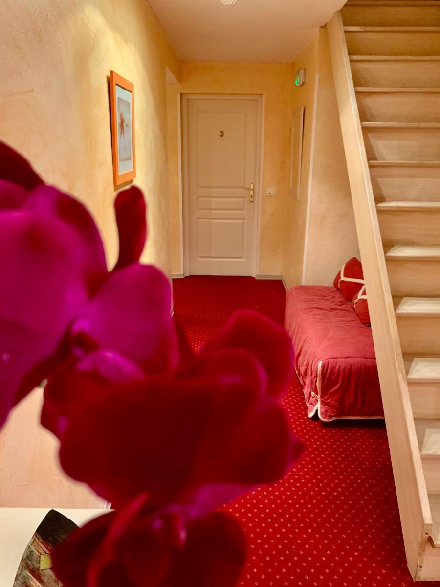 Un ou plusieurs lits dans un hébergement de l'établissement Hôtel Beau Soleil
