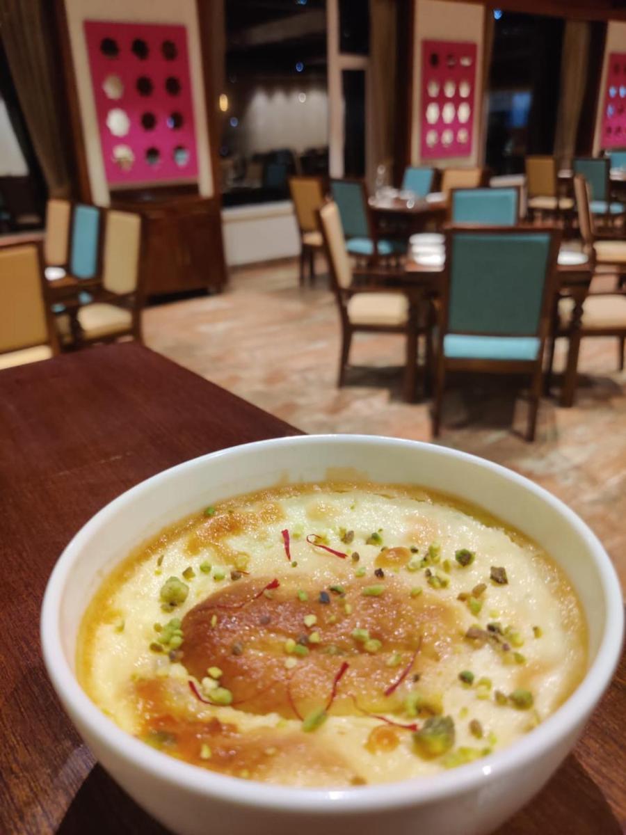 a bowl of soup on a table in a restaurant at The Orchid Shimla in Shimla