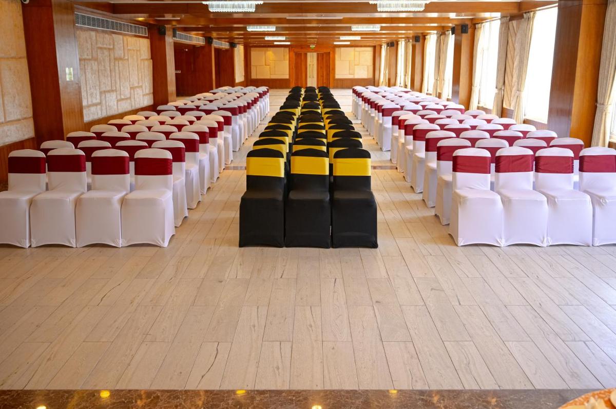 a row of chairs lined up in a hall at The Orchid Shimla in Shimla
