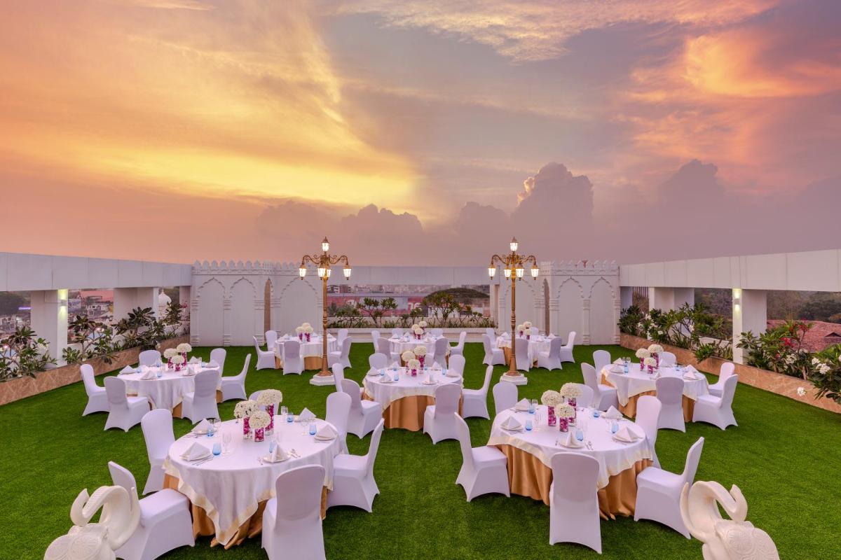 a wedding reception in a marquee with white tables and chairs at Vivanta Thiruvananthapuram in Trivandrum +25 photos