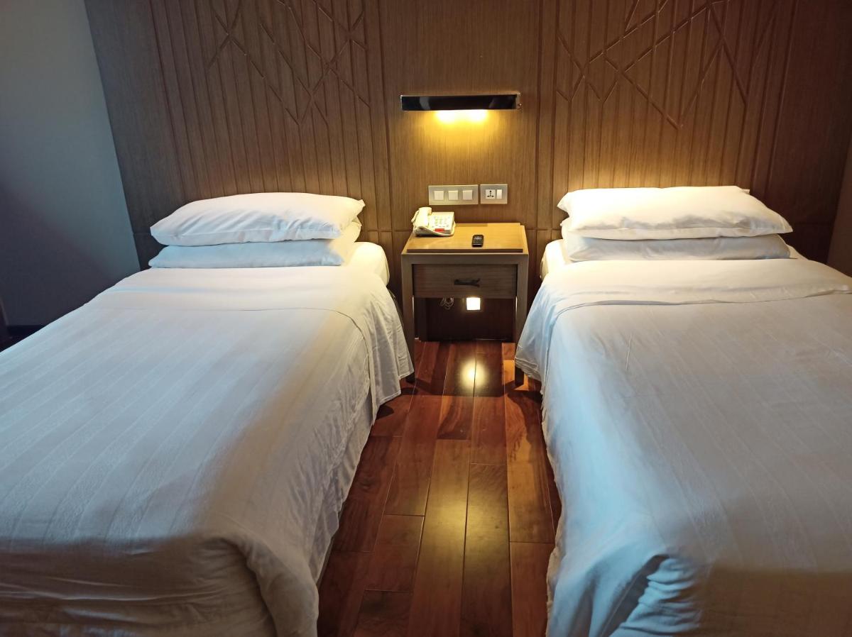a room with two beds and a phone on a table at Welcomhotel by ITC Hotels, Richmond Road, Bengaluru in Bengaluru