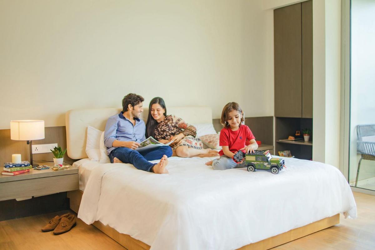 a group of people sitting on a bed at Andaz Delhi, by Hyatt in New Delhi a group of people sitting on a bed at Andaz Delhi, by Hyatt in New Delhi