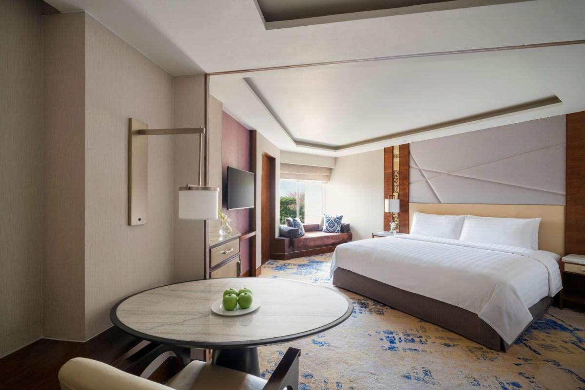 a hotel room with a bed and a table at Shangri-La Eros New Delhi in New Delhi a hotel room with a bed and a table at Shangri-La Eros New Delhi in New Delhi