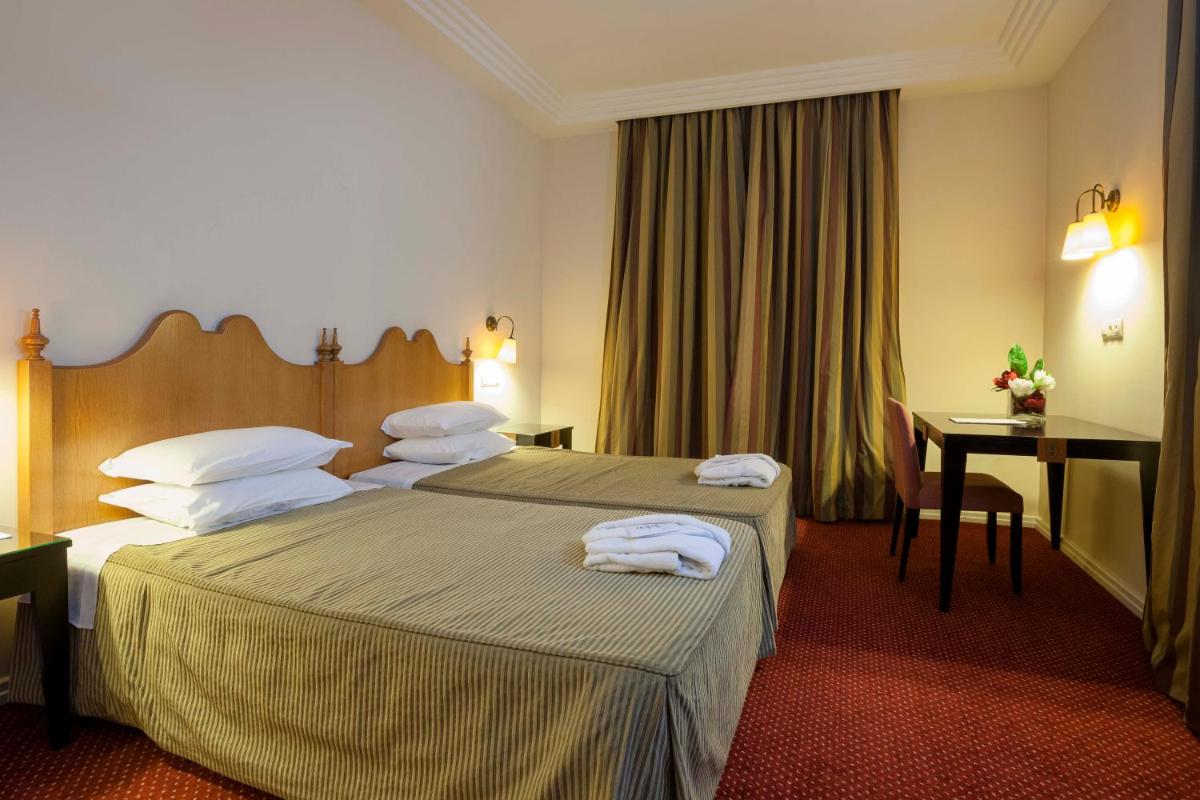 Uma cama ou camas num quarto em Hotel Termas da Curia