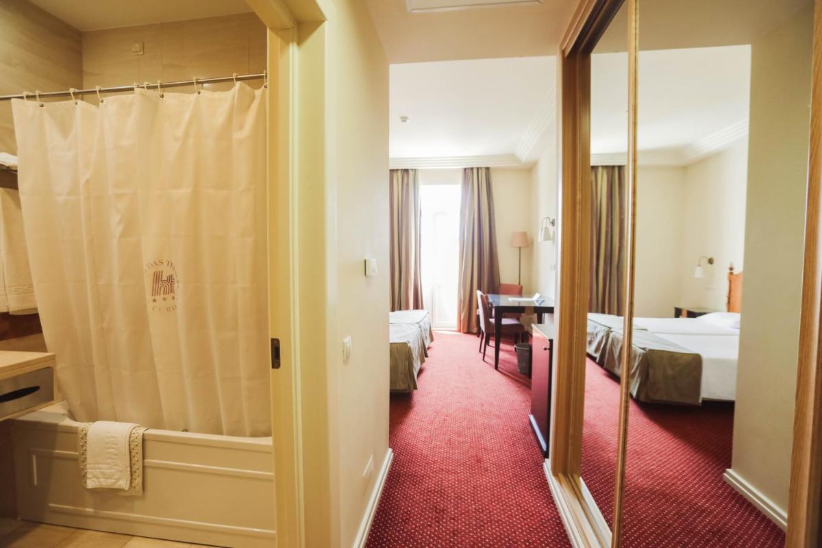 Uma cama ou camas num quarto em Hotel Termas da Curia