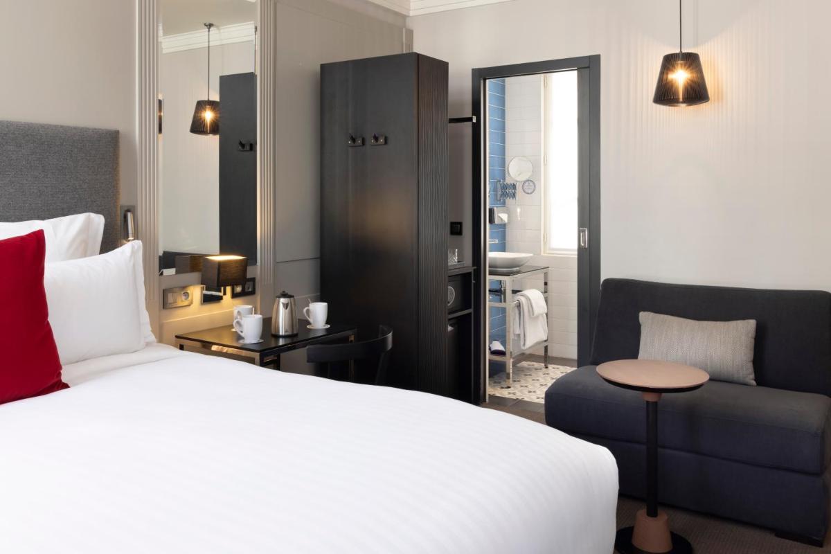 Un ou plusieurs lits dans un hébergement de l'établissement Les Matins de Paris & Spa