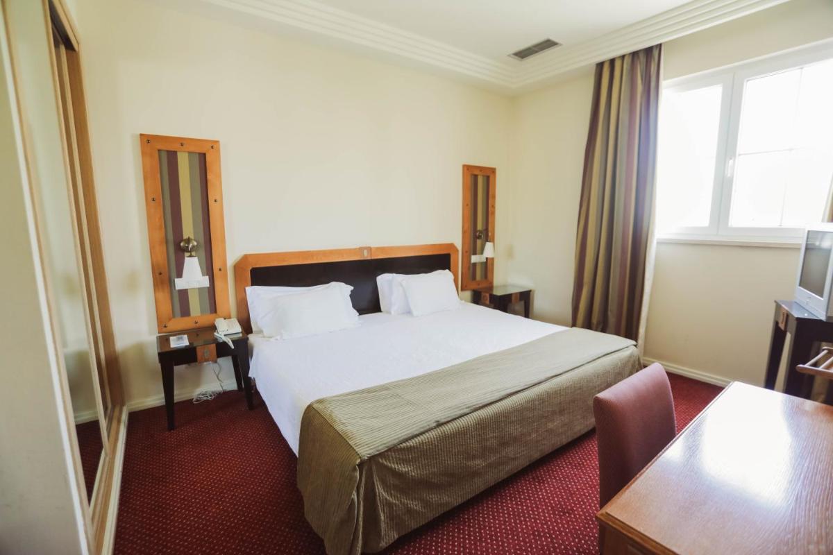 Uma cama ou camas num quarto em Hotel Termas da Curia