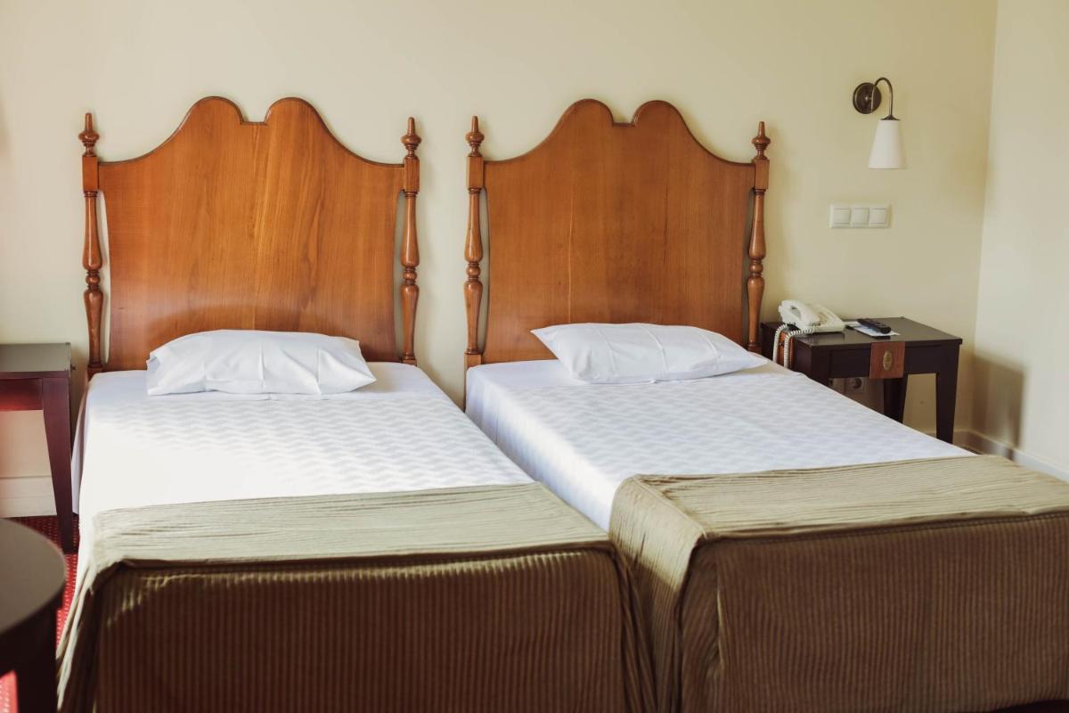 Uma cama ou camas num quarto em Hotel Termas da Curia